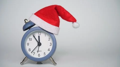 Gray alarm clock on a white background in a Santa Claus hat Video stock 315412980
