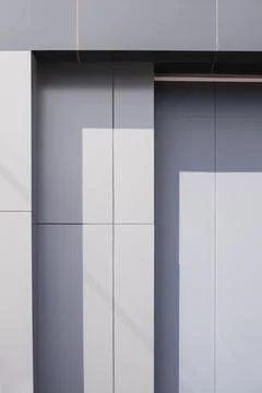 Gray aluminium composite tile wall decoration in steps pattern outside of m.. Stock Photos