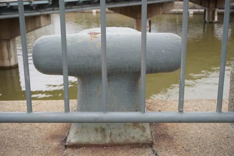 A gray anchor fixed on the concrete Фото