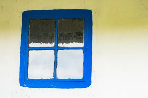Gray and gray-washed wall with blue framed window 3 small left, 1 large rig.. Stock Photos
