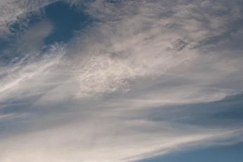 Gray and white light clouds on a blue sky Stock Photos