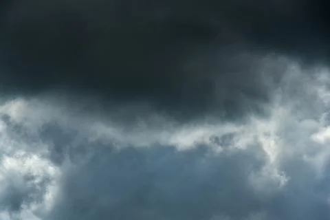 Gray and white rolling puffy clouds floating in the sky. Concept Storm Clouds Stock Photos