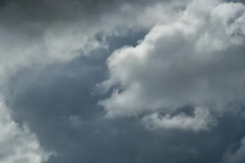 Gray and white rolling puffy clouds floating in the sky. Concept Storm Clouds Stock Photos