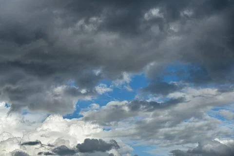 Gray and white rolling puffy clouds floating in the sky. Concept Storm Clouds Stock Photos