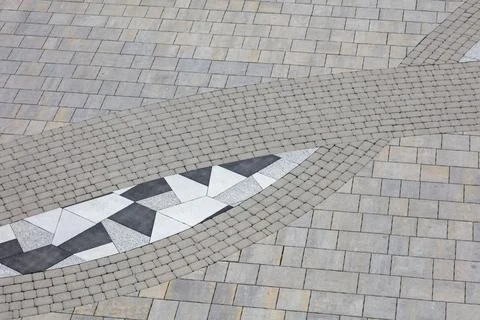 A gray and white tile pattern with a black and white triangle Stock Photos