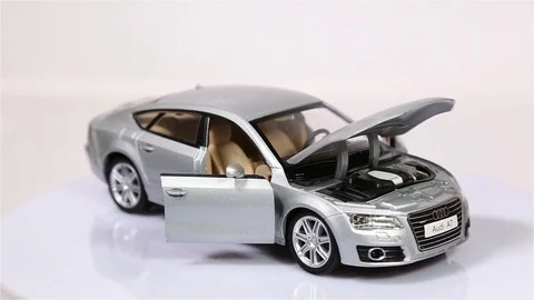 Gray Audi A7 scale model suv car with opened doors and hood is rotating isolated Stock-Footage 101688304