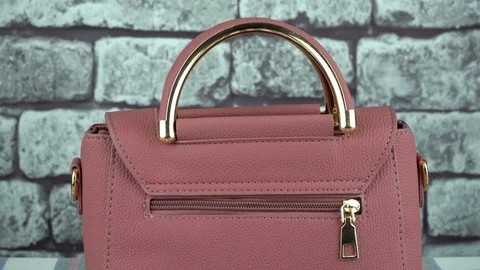 Gray background and pink bag closeup Stock Footage 103278379