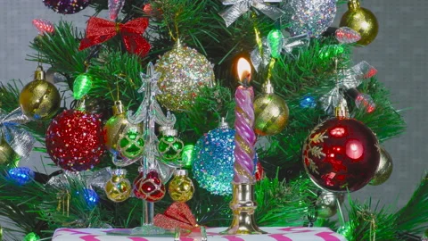 On a gray background, beautiful Christmas trees and a burning candle Stock Footage 145075869