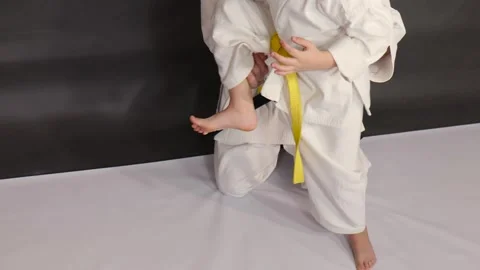 On a gray background, a coach teaches an athlete to throw a straight kick Video stock 268718491