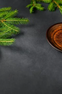 Gray Background with Live Christmas Tree Branches and Brown-orange Clay Plate Stock Photos