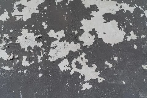 Gray background of an old wall with peeling paint. Stock Photos