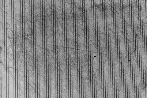 Gray background with vertical stripes, thin scratches and old worn surface .. Stock Photos
