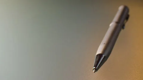 Gray ballpoint pen on glass table Stock Footage 140325115