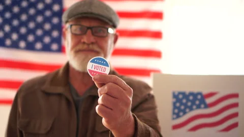 A gray-bearded pensioner in a cap and glasses voted in the elections. A man Stock Footage 141999039