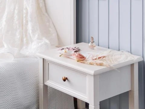 Gray bedside table with bridal accessories. Decorative monstera leaves and pa Stock Photos
