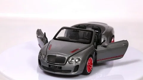 Gray Bentley Continental scale model sports car with opened doors Stock Footage 101728286