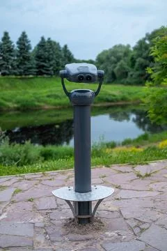 Gray binocular viewer sits on a stone pavement Stock Photos