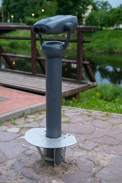 Gray binocular viewer on a stone pavement Stock Photos