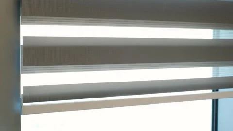 Gray blinds closing on a window close-up. Stock Footage 329600335