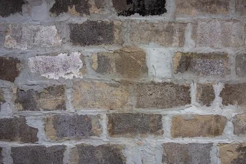 Gray block wall background. Grey textured building exterior surface with roug Stock Photos