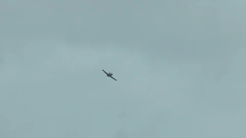 A gray blue combat fighter plane fly quickly in overcast cloudy sky. War concept Stock Footage 118677445