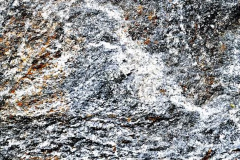 Gray-blue with ocher uneven structure granite background Foto stock