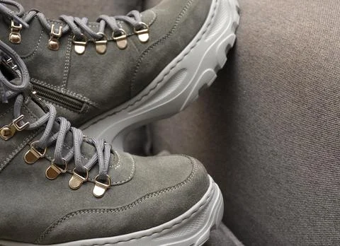 Gray Boots with laces on gray. Foto stock