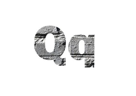 Gray brick background. Shot through the cut-out silhouette of the letter Q Foto stock