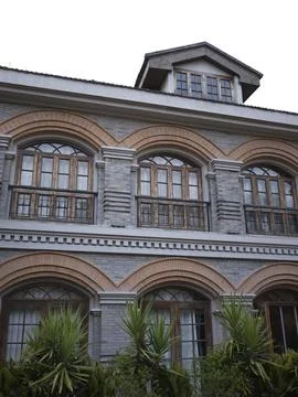 A gray-brick colonial-style building with arched windows, China Stock Photos