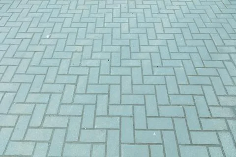 Gray brick pavement in herringbone pattern Stock Photos