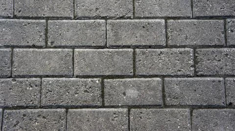 Gray brick stone road. Pavement texture photography. Stock Photos