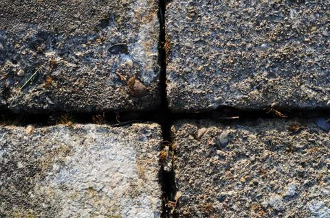 A gray brick surface texture that is worn and old Stock Photos