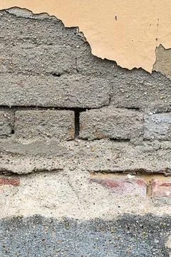 Gray brick wall and shards of putty background wall old house close-up Stock Photos