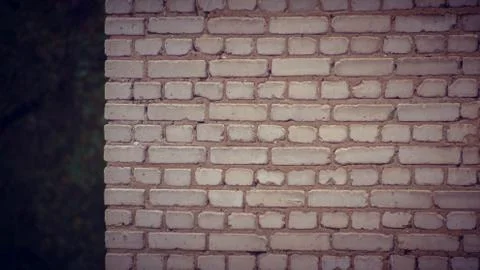 Gray brick wall at the corner of the house Stock Photos