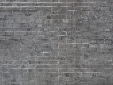 A gray brick wall with dark and light spots of dirt and smudges. Not seamless 스톡 사진