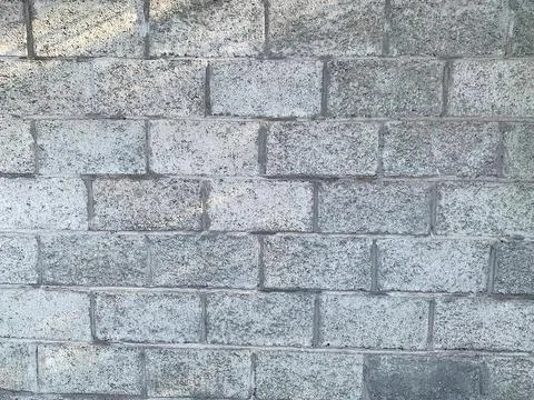 Gray brick wall made of sand-cement bricks Stock Photos