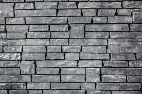 Gray brick wall with rough texture Stock Photos