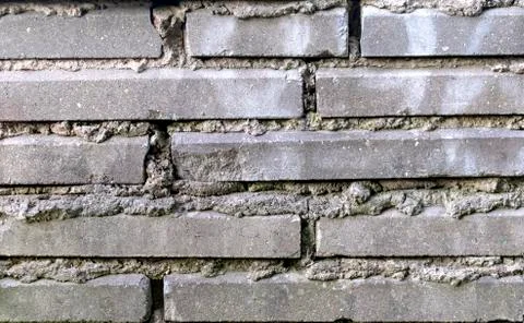 Gray brick wall texture and background closeup. Stock Photos