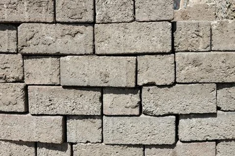 Gray brick wall texture and background with natural shadows Stock-Fotos