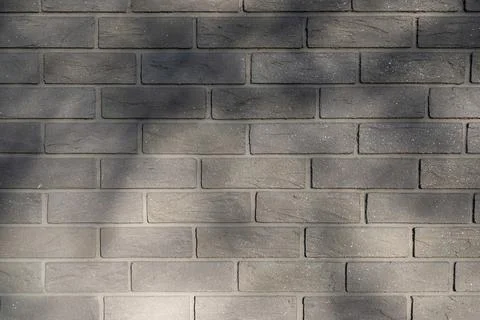 Gray brick wall texture with soft shadows Stock Photos