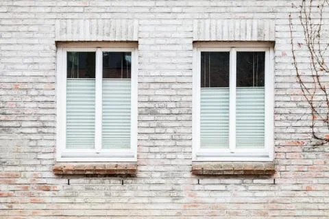 Gray brick wall with two windows Stock Photos