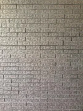 Gray brick wall with uniform rectangular pattern Foto stock