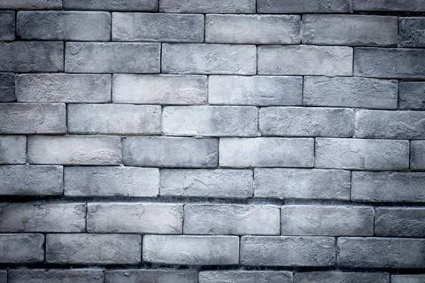 A gray brick wall with a white line running down the middle Stock Photos