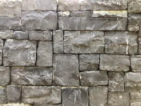 Gray bricks stone wall background texture Stock Photos