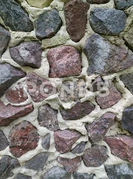 Gray, brown, black stone wall background, granite mosaic stonewall rubble fac Stock Photos