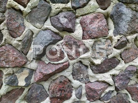 Gray, brown, black stone wall background, granite mosaic stonewall rubble fac Stock Photos