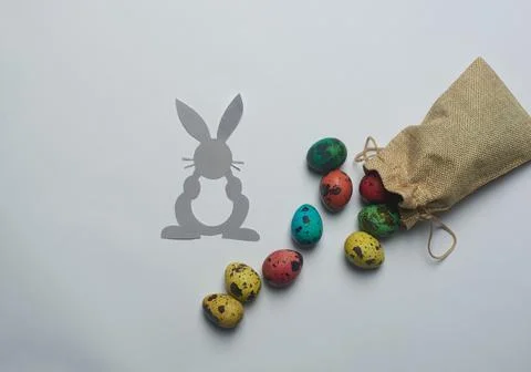 Gray bunny and a bag of Easter eggs Stock Photos