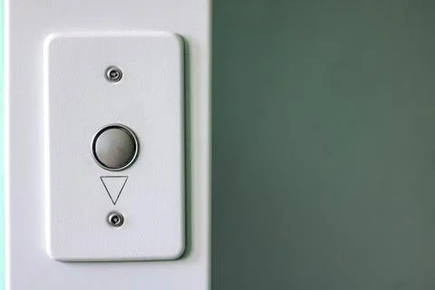 Gray button for calling up the elevator close up Stock Photos