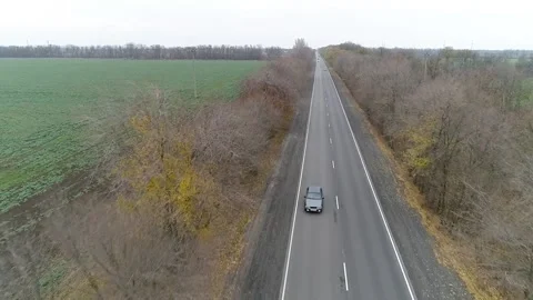 Gray car drives fast along highway outside the city Stock Footage 169510014
