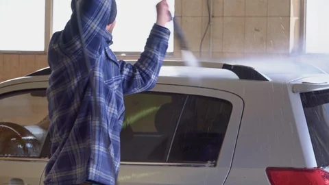 Gray car is washed with high-pressure water at a car wash Stock Footage 105967076